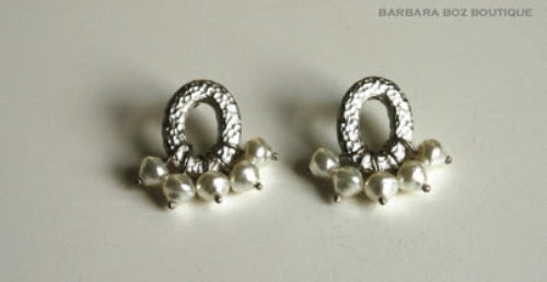 top view of organic-shaped silver earrings