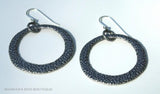 top view of organic-shaped silver earrings