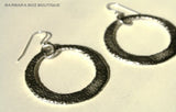 top view of organic-shaped silver earrings