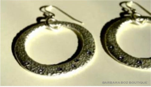 top view of organic-shaped silver earrings