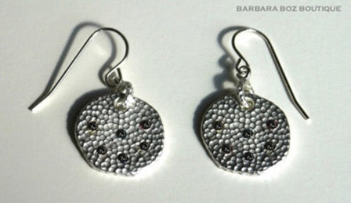 top view of organic-shaped silver earrings