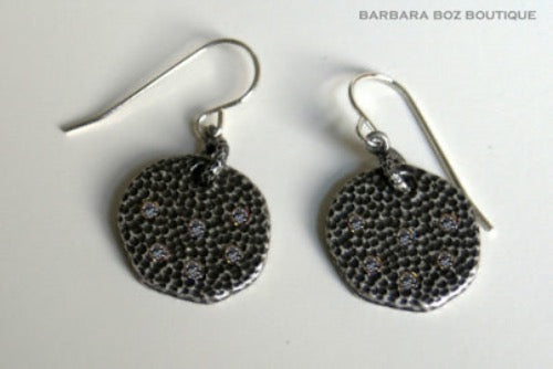 top view of organic-shaped silver earrings 