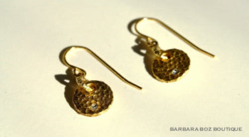 closeup of organic-shaped gold earrings