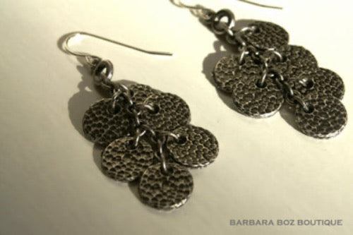 top view of organic-shaped silver earrings