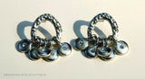 closeup of organic-shaped silver earrings