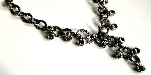 closeup of organic-shaped silver necklace