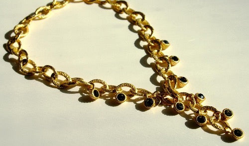 closeup of organic-shaped gold necklace