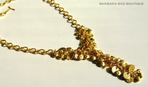 closeup of organic-shaped gold necklace