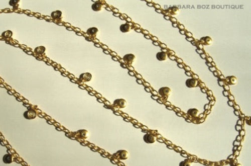 closeup of organic-shaped gold necklace