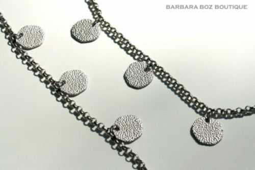 closeup of organic-shaped silver necklace