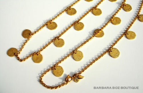 closeup of organic-shaped gold necklace