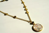 closeup of organic-shaped gold necklace