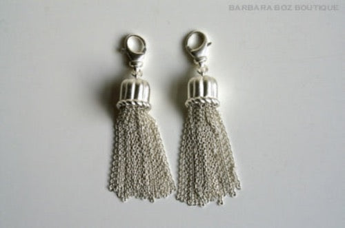 top view of organic-shaped silver tassels