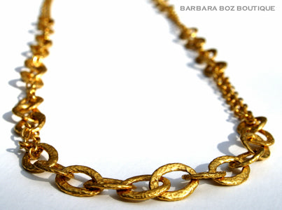 closeup of organic-shaped gold necklace