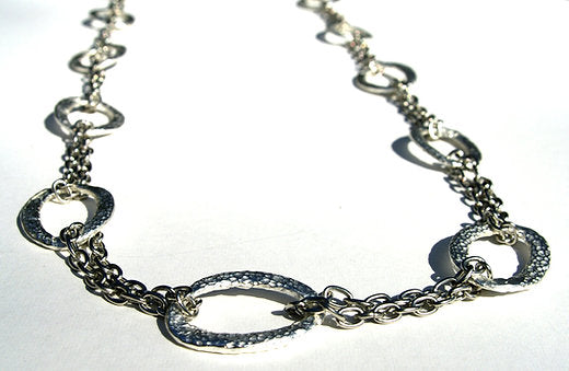 closeup of organic-shaped silver necklace