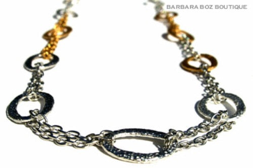 closeup of organic-shaped gold and silver necklace