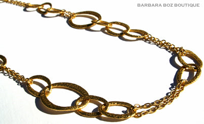 closeup of organic-shaped gold necklace