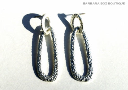 top view of organic-shaped silver earrings