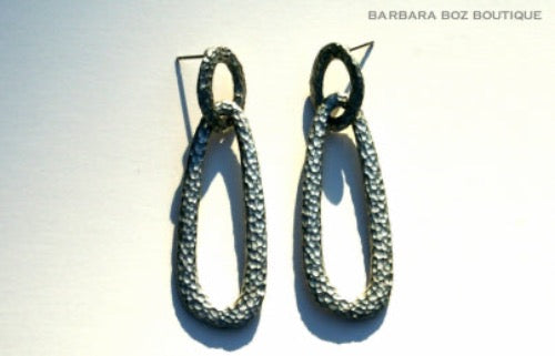 top view of organic-shaped silver earrings