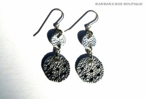 top view of organic-shaped silver earrings