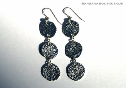 top view of organic-shaped silver earrings