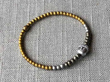 heishi bead bracelet comprising buddha bead, pyrite and metallics