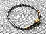 heishi bead bracelet comprising buddha bead, pyrite and metallics