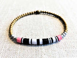 heishi bead bracelet comprising vinyl discs in a black and white mix and metallic beads