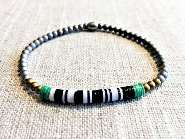 heishi bead bracelet comprising vinyl discs in a black and white mix and metallic beads