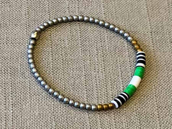 heishi bead bracelet comprising vinyl discs in a green and white racing stripe and metallic beads