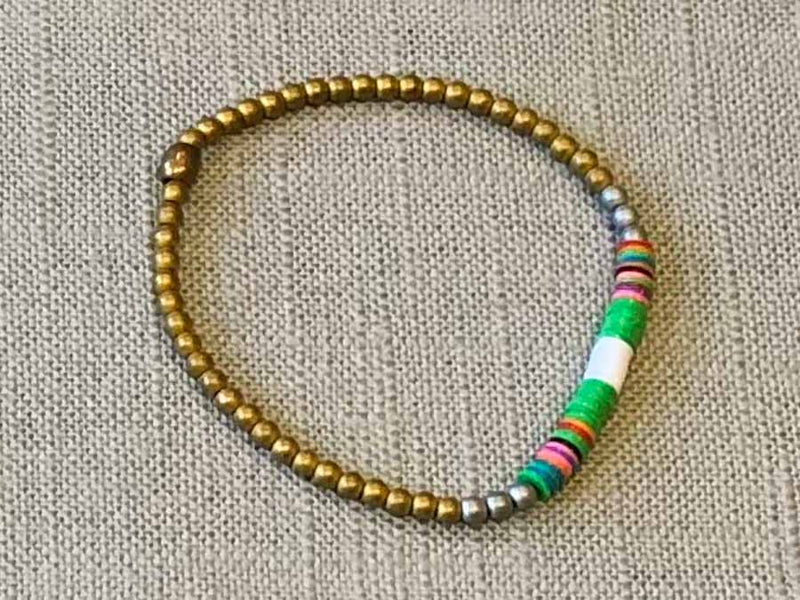 heishi bead bracelet comprising vinyl discs in a green and white racing stripe and metallic beads