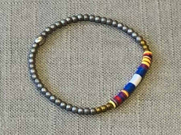 heishi bead bracelet comprising vinyl discs in a blue and white racing stripe and metallic beads