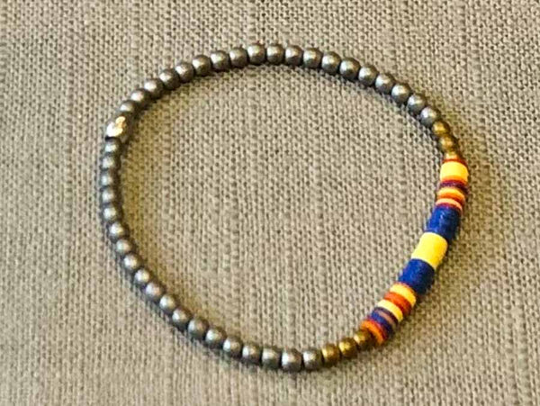 heishi bead bracelet comprising vinyl discs in a blue and yellow racing stripe and metallic beads