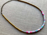 heishi necklace comprising vinyl discs in a pink multi mix and metallic beads