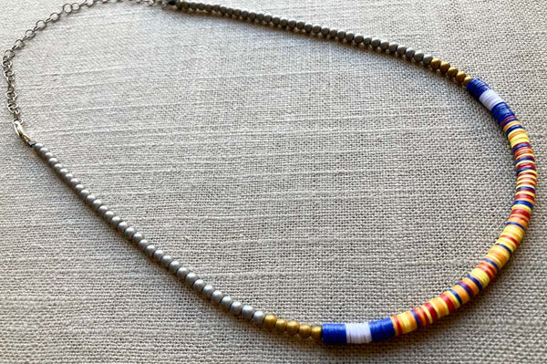 heishi necklace comprising vinyl discs in a blue multi mix and metallic beads