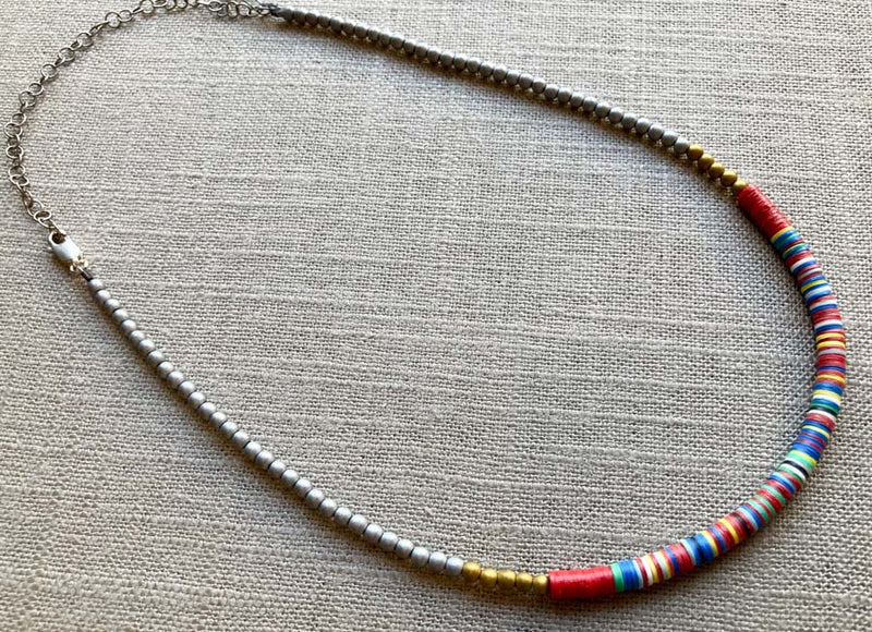 heishi necklace comprising vinyl discs in a red multi mix and metallic beads