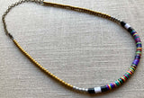 heishi necklace comprising vinyl discs in a purple multi mix and metallic beads