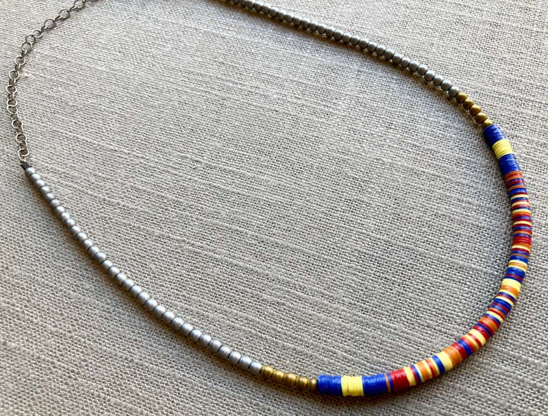 heishi necklace comprising vinyl discs in a blue multi mix and metallic beads