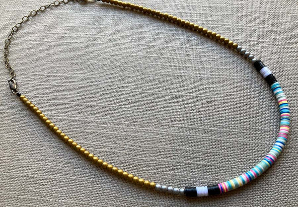 heishi necklace comprising vinyl discs in a pink multi mix and metallic beads