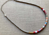 heishi necklace comprising vinyl discs in a red multi mix and metallic beads