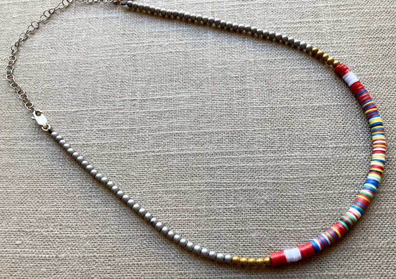 heishi necklace comprising vinyl discs in a red multi mix and metallic beads