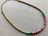 heishi necklace comprising vinyl discs in a pink multi mix and metallic beads