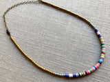 heishi necklace comprising vinyl discs in a purple multi mix and metallic beads