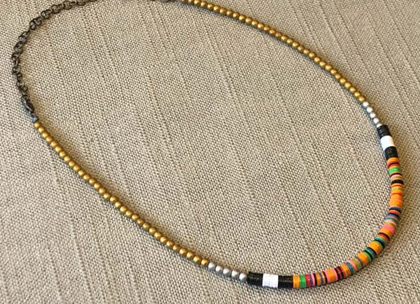 heishi necklace comprising vinyl discs in an orange multi mix and metallic beads