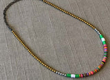 heishi necklace comprising vinyl discs in a green multi mix and metallic beads