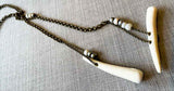 closeup  of antler lariat on large bronze rolo chain