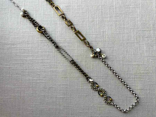 top view of fragment chain necklace with vintage and reclaimed chain elements and various trade beads