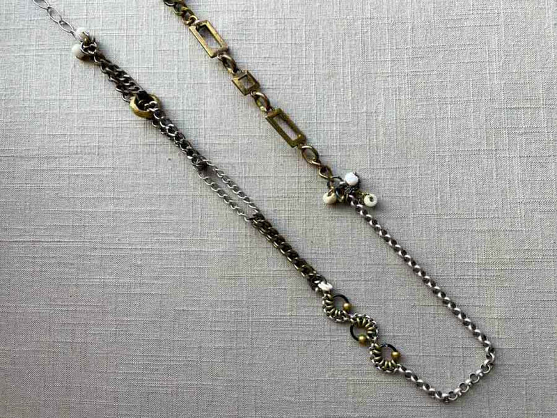 top view of fragment chain necklace with vintage and reclaimed chain elements and various trade beads