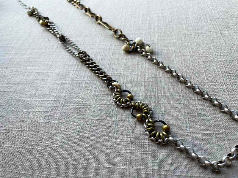 top view of fragment chain necklace with vintage and reclaimed chain elements and various trade beads