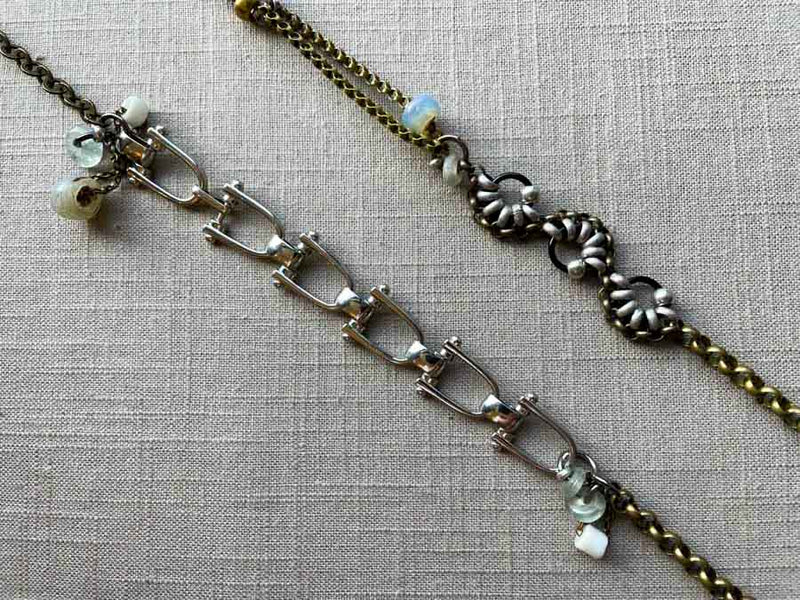 closeup of fragment chain necklace with vintage and reclaimed chain elements and various trade beads